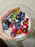 Pop culture themed glass milli pendants