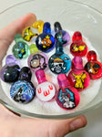 Pop culture themed glass milli pendants