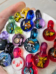 Pop culture themed glass milli pendants